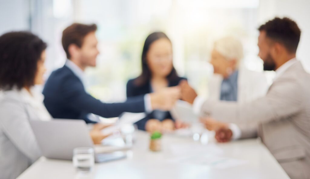 Defocused shot of a group of diverse businesspeople having a meeting in an office boardroom. Blurre